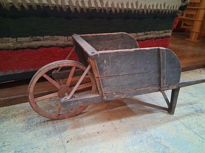 Antique Wood Wheelbarrow w/ Spoked Wheel & Iron. 53 inch long. This antique wooden wheelbarrow 