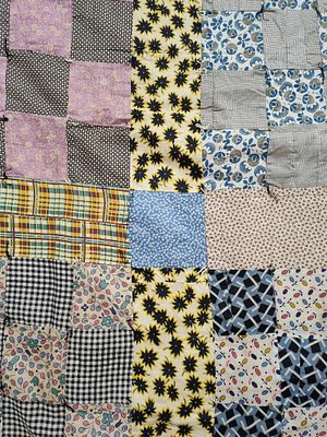 Mid-Century American Hand-Pieced and Hand-Tied Cotton and Suiting Patchwork Utility Quilt. 71 x 