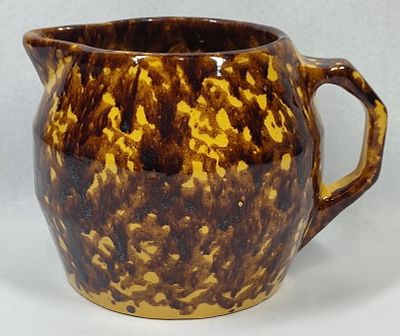 Rockingham Glaze Yellowware Pitcher. This 19th-century earthenware pitcher, possibly of American 