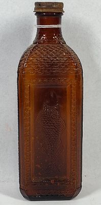 McKesson Embossed Fish Amber Oil Bottle. 9 in. An antique amber glass medicinal bottle 