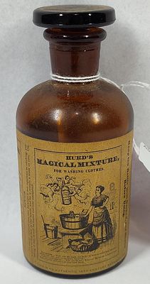 14) (15) H(20) (21) M(28) (29) M(36). 5 inches.This amber glass bottle with a black glass 