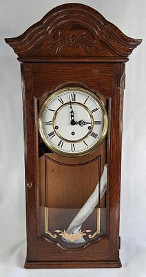 Howard Miller Model 612-578 Le Sauterne Triple Chime Oak Wall Clock. 27 in tall 10.5 wide and 