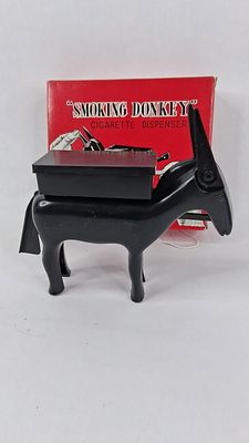 Smoking Donkey Plastic Cigarette Disp. This vintage mechanical cigarette dispenser is designed 