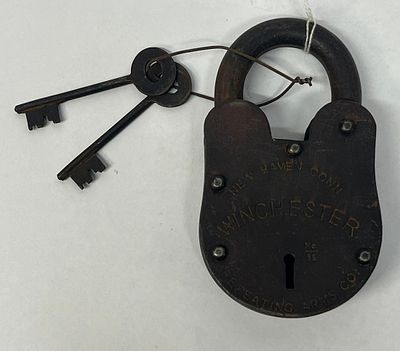 Winchester Repeating Arms Iron Padlock. A wrought iron lever-tumbler pancake style padlock 