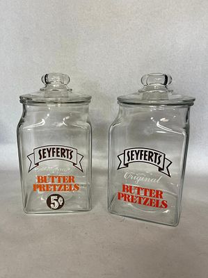 Pair Seyfert's Glass Pretzel Jars. A pair of mid-20th-century clear pressed glass countertop 