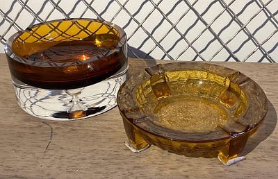 Pair Mid-C. Modern Amber Glass Ashtrays. This lot features two mid-century modern amber glass 