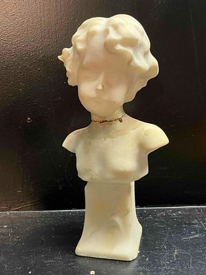 Alabaster Child Portrait Bust. A carved alabaster sculpture depicting the head and chest of a 