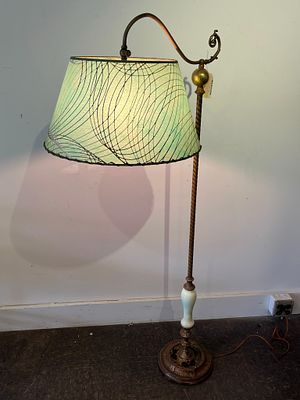 Cast Metal Bridge Lamp w/ Uranium Glass. This floor lamp features an ornate cast metal base and 