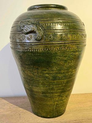 Southeast Asian Jar w/ Fish, Green. This large ceramic jar is a functional storage vessel of 