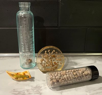 Dr. Kilmer Bottle, Fossils & Brooch. This lot features a sample-sized apothecary bottle, an 