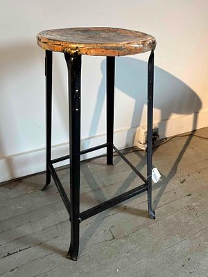 Industrial Black Steel Bar Stool. An industrial-style bar stool featuring a round metal seat 