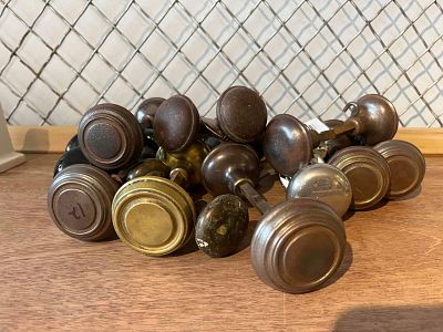 Brass, Bronze & Porc. Doorknobs. An assortment of American residential door hardware from the 