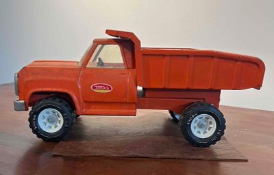 Tonka Pressed Steel Orange Dump Truck. A pressed steel dump truck manufactured by Tonka. The 