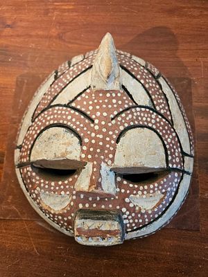 West African Wood Owl Spirit Mask. A hemispherical carved wooden mask featuring a central 