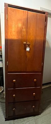 American Mid-Century Cabinet w/ Drawers. A tall, narrow storage cabinet of single-piece 