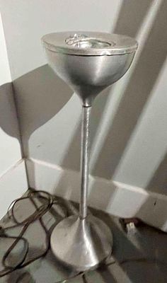 Brushed Aluminum Floor-Standing Ashtray. A floor-standing ashtray constructed of brushed 