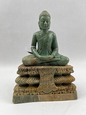 Southeast Asian Seated Stone Buddha. A carved variegated green stone statue depicting a seated 