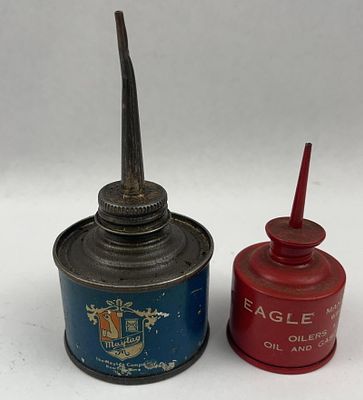 Maytag Blue Thumb & Eagle Red Oilers. A pair of vintage thumb-press metal oil cans. The front of 