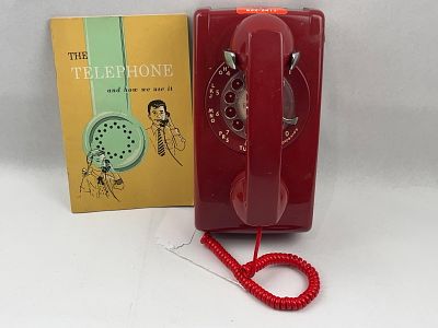 Western Electric 554BMP Red Wall Phone. A vintage wall-mounted rotary dial telephone featuring a 