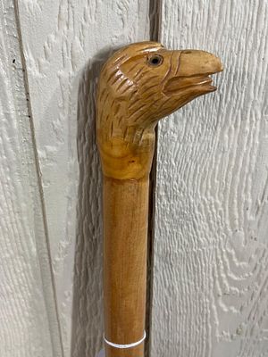 Carved Wood Eagle Head Walking Stick. This walking stick is crafted from a light-colored 