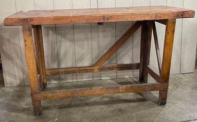 Industrial Braced Wood Workbench. An industrial wood workbench featuring a thick, multi-board 