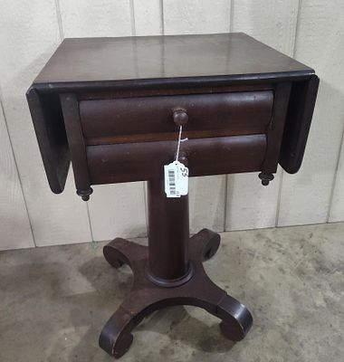 American Empire Drop-Leaf Sewing Table. A mid-nineteenth century mahogany sewing or work table 
