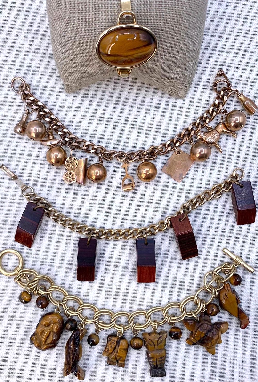 Lot 270: 4 Vintage Carved Animal Totem Tigers Eye, Wood, Gilded Metal Charm and Cuff Bracelets
