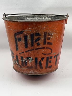 Painted Metal Fire Bucket. Height: 10.75 inches. A galvanized metal fire bucket featuring a 