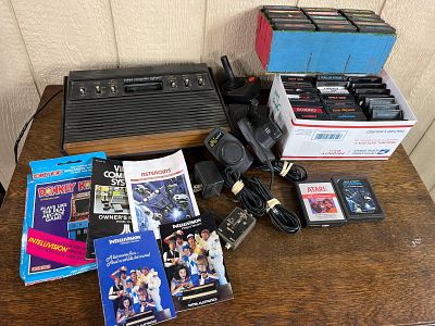 Atari 2600 Console, Controllers & Games. A home video game console collection featuring the 