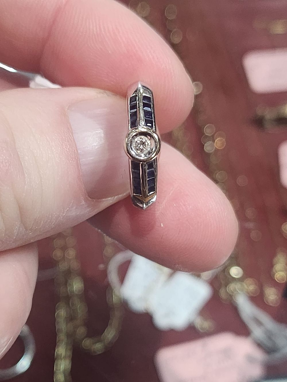 Lot 174: 18ct White gold with a single natural diamond and blue Sapphires. Size M.. please note this item mite show signs of wear and tear pre loved...
