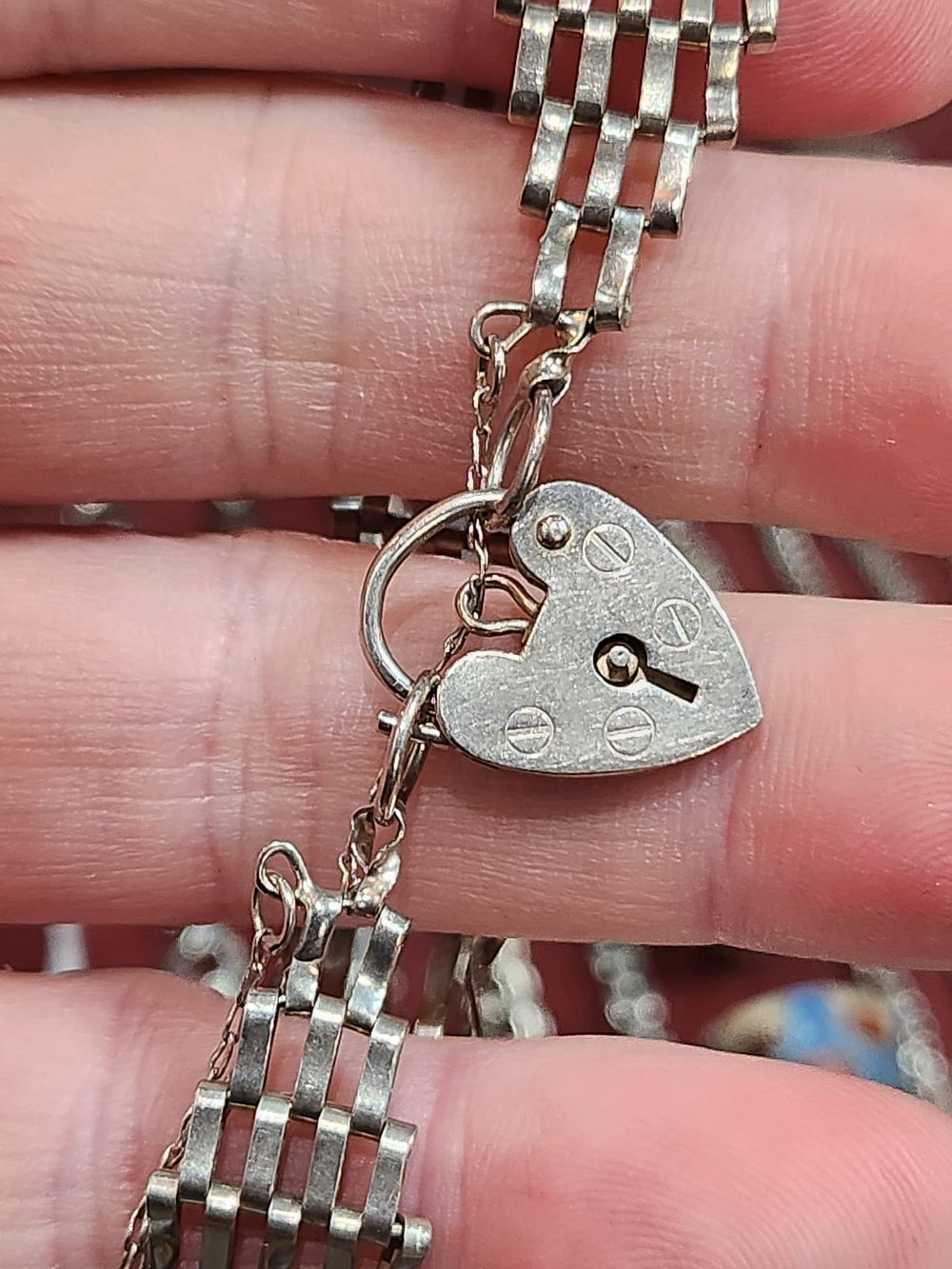 Lot 186: Silver Hallmarked 5 gate bracelet with safety chain