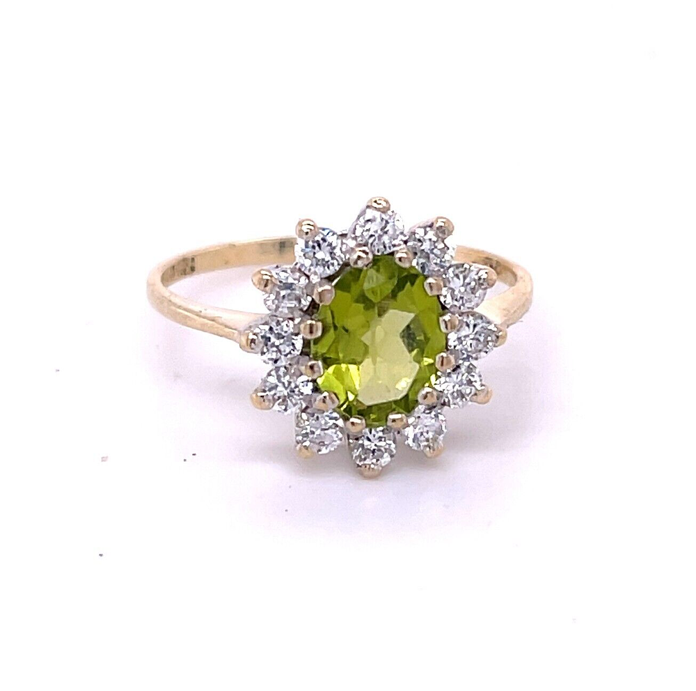 Lot 241: 9ct Yellow Gold Peridot Cocktail Ring with 12 CZ Stones Hallmarked 375 This beautiful ring has been professionally cleaned/polished and is ready to wear. Fully hallmarked for 9ct solid gold. Ring Size: N  Additional Info: Set with 12 CZ stones and 1 large