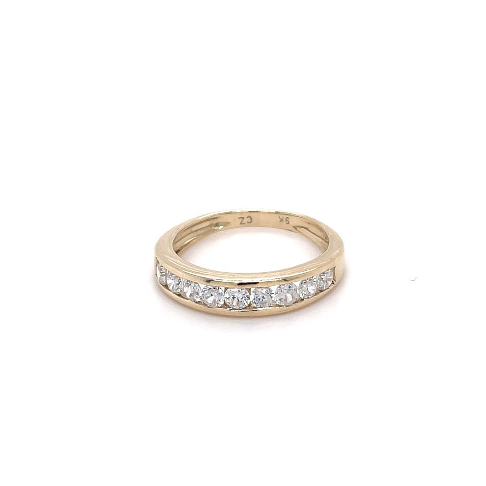 Lot 242: 9ct Yellow Gold Channel Set CZ Designer Eternity/Promise Ring Hallmarked Size N This beautiful ring has been professionally cleaned/polished and is ready to wear. Fully Hallmarked 9ct solid gold. Ring Size: N Additional Info: Set with 9 CZ stone with a we