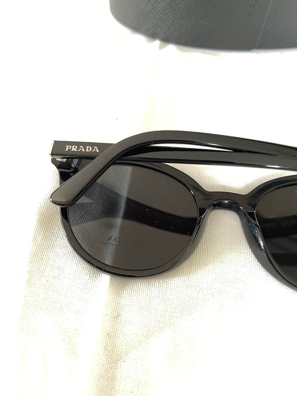Lot 312: Prada Ladies black sunglasses, ex demo from a private jet charter. Please see photos for condition.