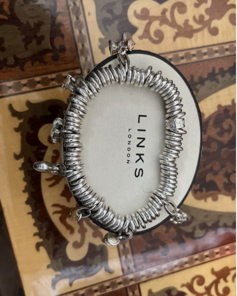 Lot 347:  Links of London Sweetie Bracelet & Charms x7. Condition is fantastic, elastic is also in really good condition. Weighs 98g
