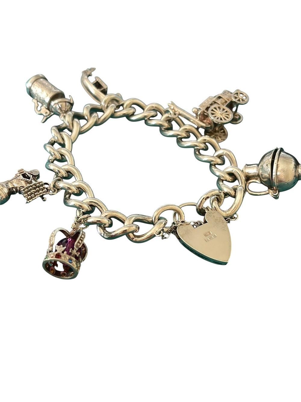 Lot 344: vintage solid sterling silver charm bracelet, complete with a working heart-shaped padlock