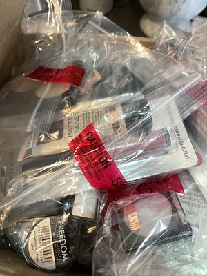 Security-sealed mystery clearance bundle containing branded high-street cosmetics and retail 