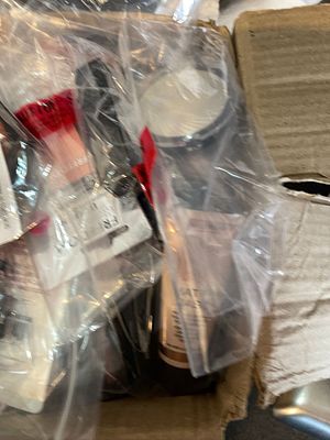 Security-sealed mystery clearance bundle containing branded high-street cosmetics and retail 