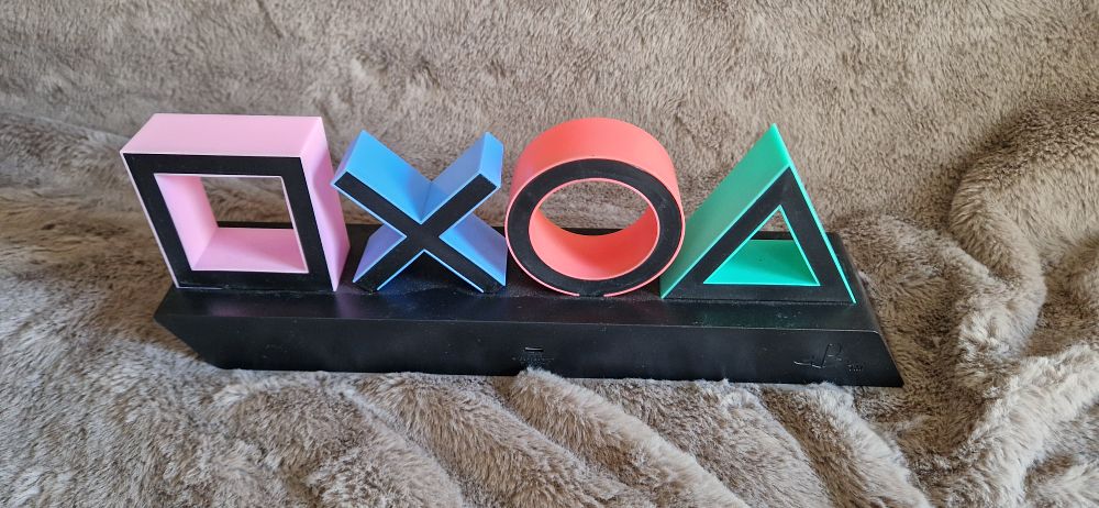 Lot 1139: Paladone PlayStation Icons Table Light featuring the iconic controller symbols.