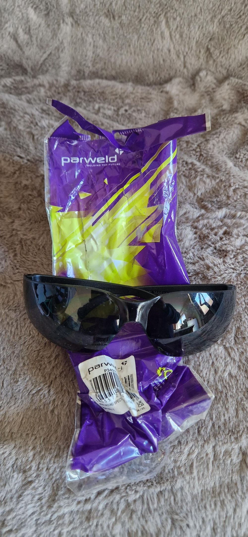 Lot 1151: safety glasses positioned over its original Parweld packaging.