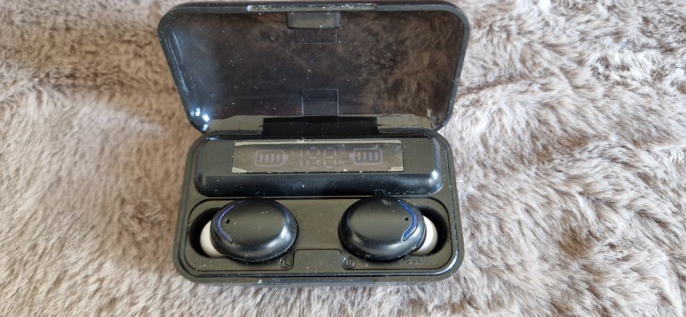 Lot 1171: A pair of TWS BTH-F9-5 wireless earbuds in their charging case.