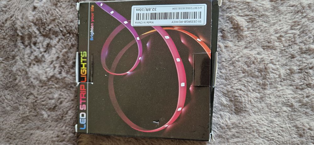 Lot 1177: 10m (32.8ft) 5V RGB LED strip light kit with a 24-key infrared remote control.