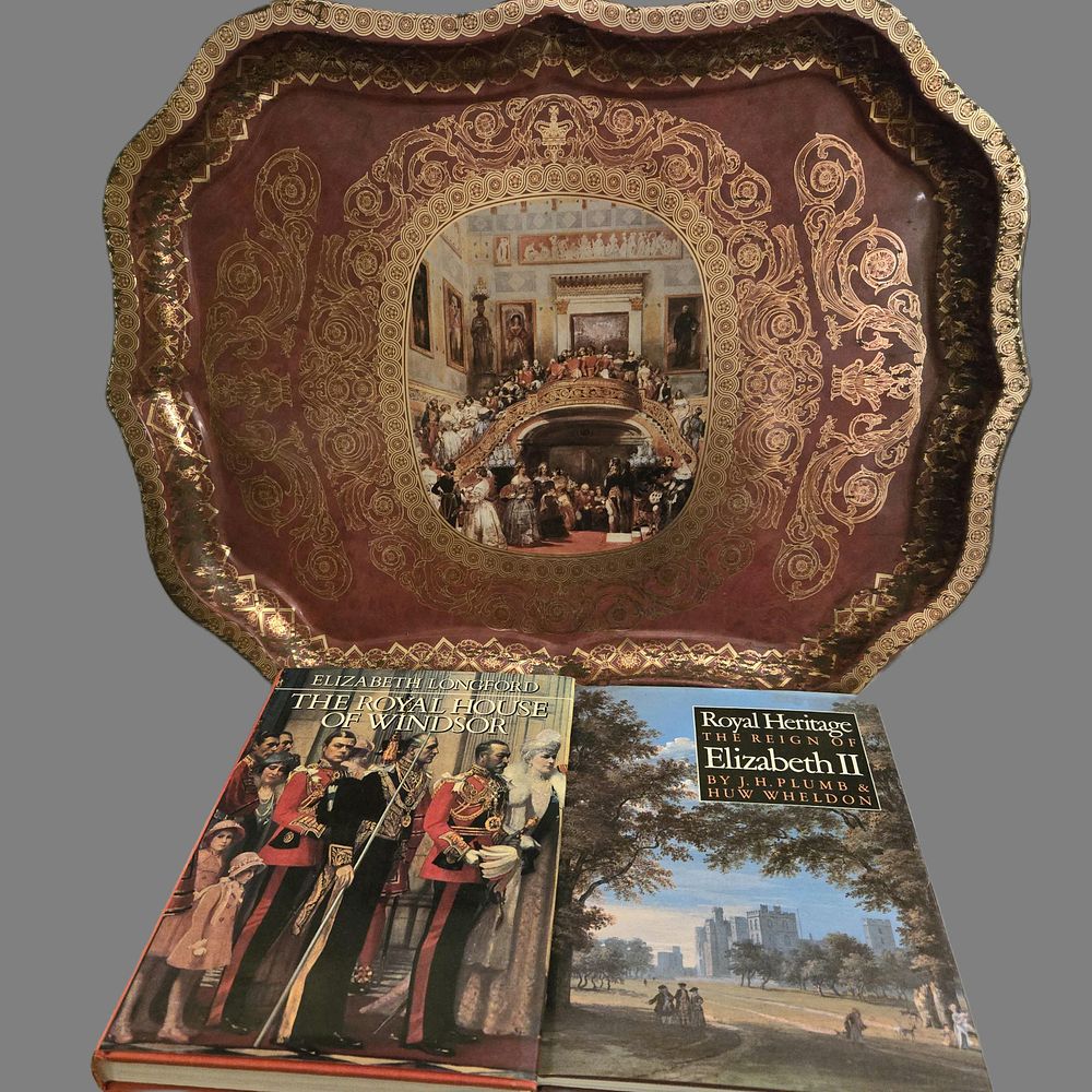Lot 1269: A selection of royal memorabilia to include a large metal tray featuring Queen Victoria and a hardba