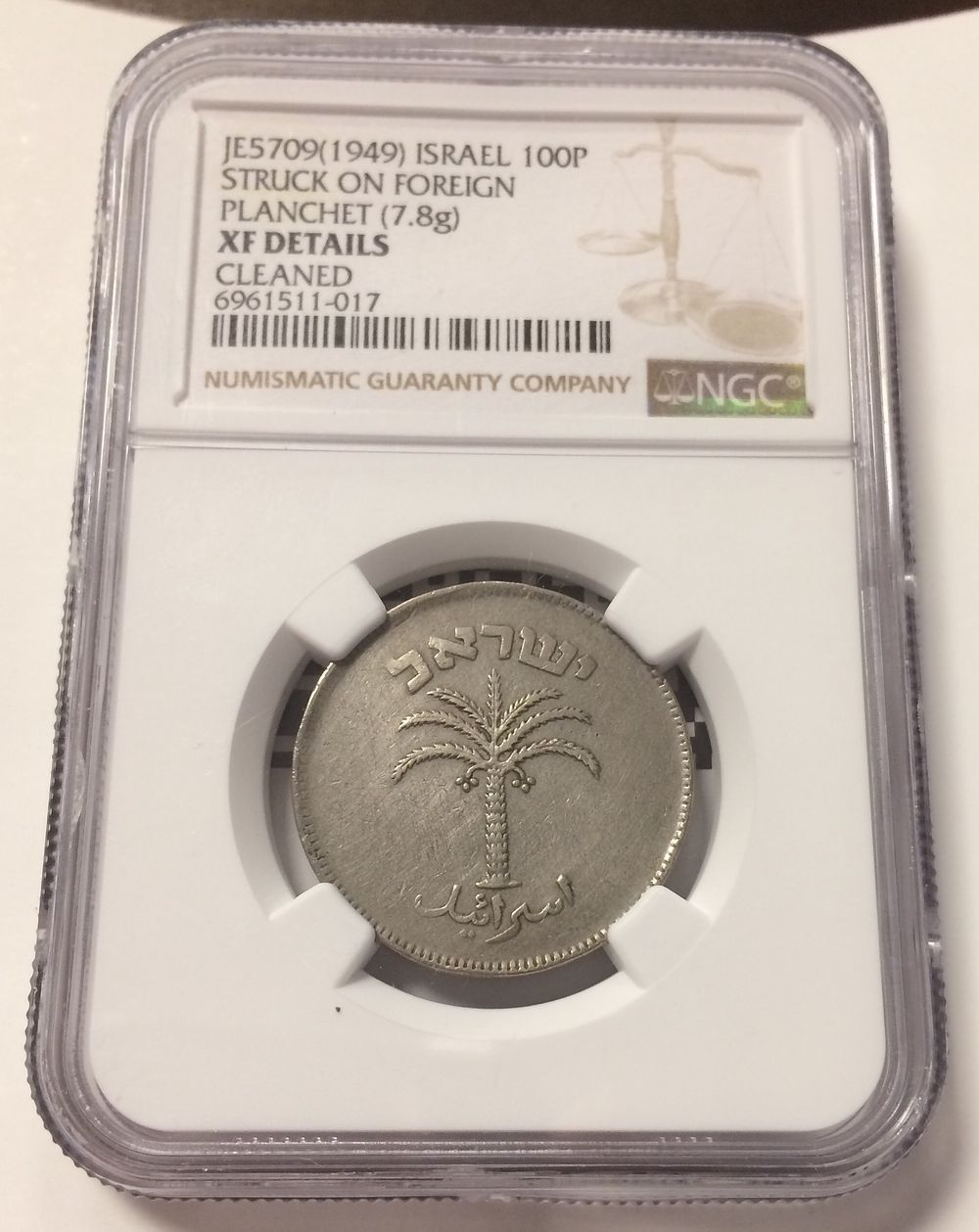 Israel , Coin Struck on foreign planchet Error in 100 pruta 1949 graded by NGC XF details . Israe 