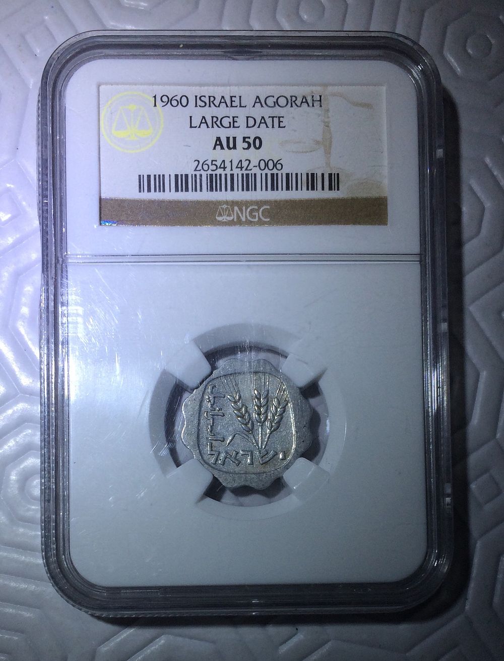 ישראל, מטבע 1 אגורה 1960 ״תש״ך גדול״ מדורג NGC AU50 במצב כמעט חדש עם ברק מטבעה טבעי בין הפריטים 