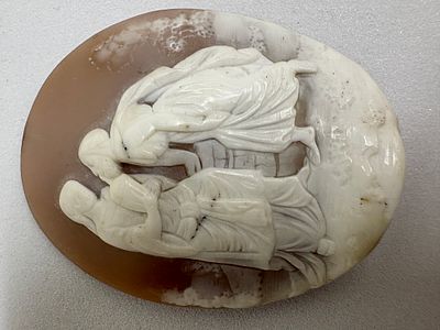 Carved Shell Cameo Depicting Two Figures by a Well. An oval white and brown shell cameo 