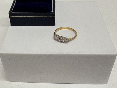 A 18K Two-Tone Gold Three-Stone Diamond Ring.
one carat total