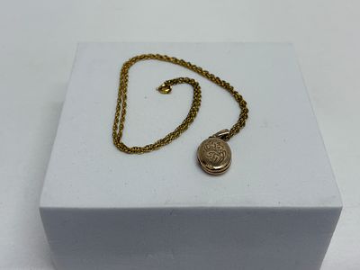 A Vintage 9ct Gold Engraved Oval Locket Pendant with rolled gold Chain.
locket 2.19g