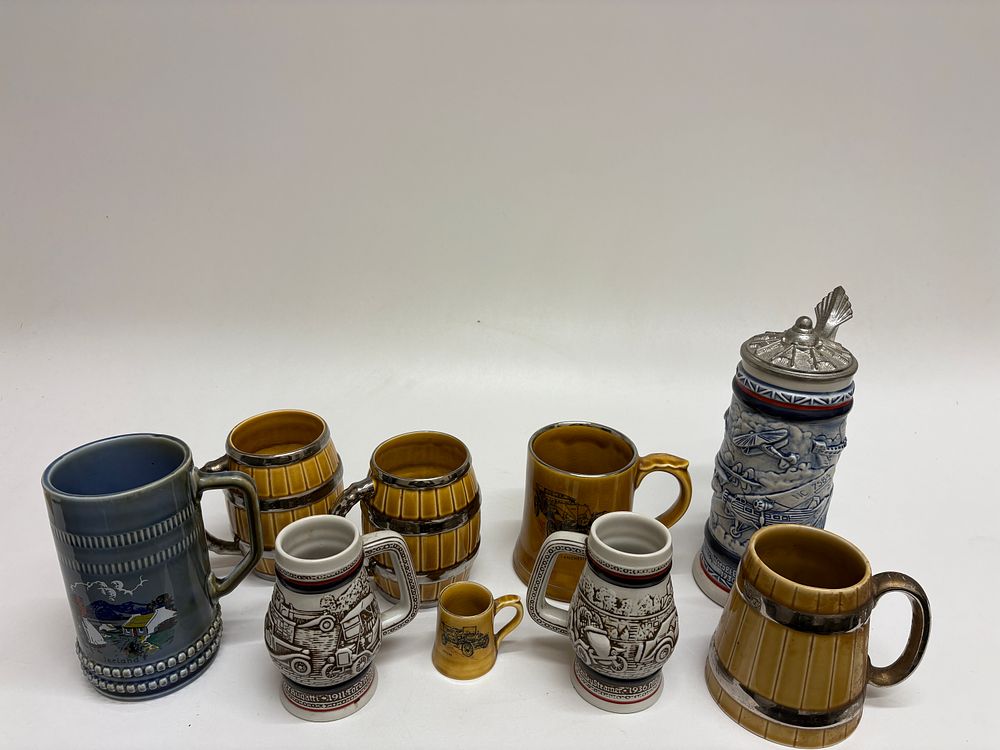 Lot 603: A Collection of Ten Mid-to-Late 20th Century German Style Ceramic Steins and Mugs, including Avon and Wade Examples