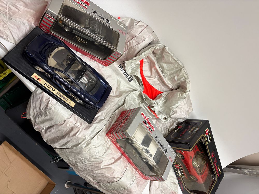 Lot 640: A Vodafone McLaren Mercedes Team Jacket and a Collection of Four Die-Cast Model Cars by Bburago, Majorette, and Maisto